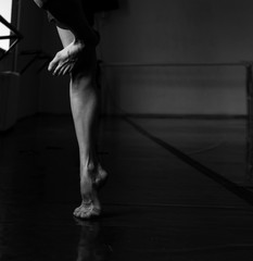 Ballet Dancer Point and Leg , intentionally shoot at High ISO to give grainy and dramatic feel, selective noise reduction applied, Low Key, Black and White Studio Shot - 318927781