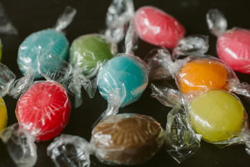 Heap of multicolor fruity candies as texture and background for design. Many different candies of different flavors.