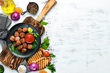 Baked Beef Meatballs with Ketchup on a Black Plate. Top view. Free space for your text.