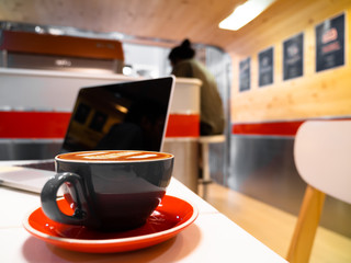 Use a laptop or notebook in a cafe.