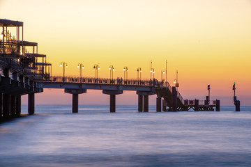 Baltic sea at beautiful sunset in Miedzyzdroje beach. Polish baltic coast. Famous city among the tourist. Pier at sunset