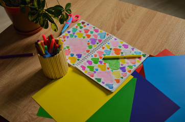 Multi-colored hearts drawn in a notebook. Close-up photo.