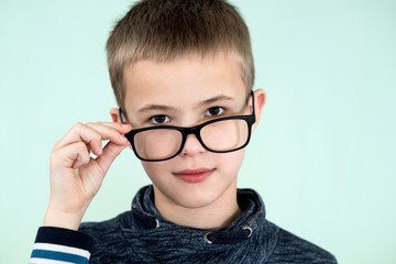 Close up portrait of a child school boy wearing glasses.