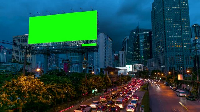 4k - Advertising billboard green screen on sidelines of expressway with traffic at evening, time lapse.
