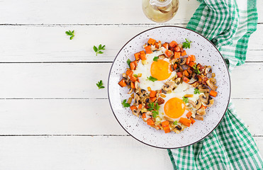 Ketogenic food. Fried egg, mushrooms and sliced pumpkin. Keto, paleo breakfast. Top view, overhead, copy space
