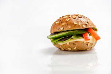 Healthy vegetarian burger with cheese and vegetables on white background