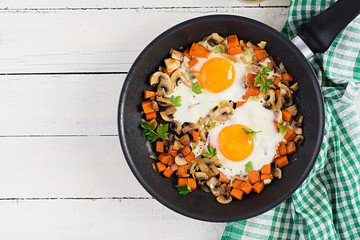 Ketogenic food. Fried egg, mushrooms and sliced pumpkin. Keto, paleo breakfast. Top view, overhead, copy space