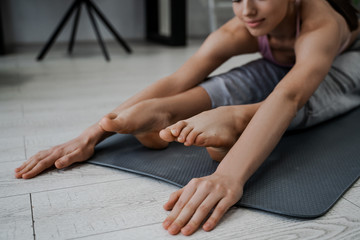 Stretching, morning exercises, warm-up before work. Young athletic strong woman does sports yoga in the morning at home, morning exercises and warm-ups, healthy lifestyle and personal care
