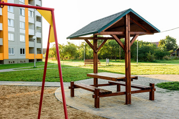 Fototapeta na wymiar Colorful activities playground on the sand in the park. The concept of childhood of the urban area.