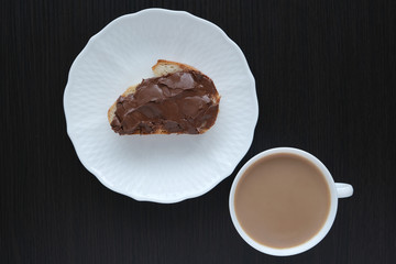 cup with coffee and sandwich with walnut, chocolate paste