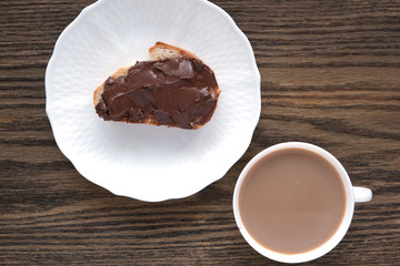 cup with coffee and sandwich with walnut, chocolate paste