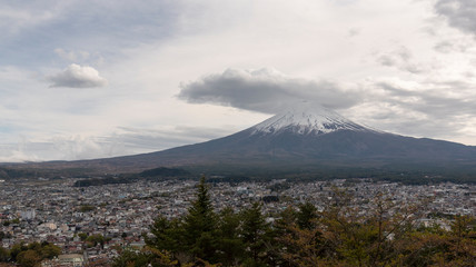 Snowcapped and cloud hat phenomena against the most beautiful volcano of the world Mt. Fuji with Kawaguchigo city .