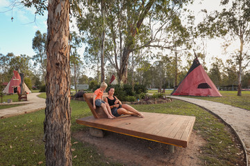 Mother and son relaxing at tipi camp ground © Caseyjadew