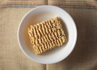 raw, brewed noodles on a light burlap background