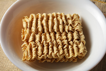 raw, brewed noodles on a light burlap background