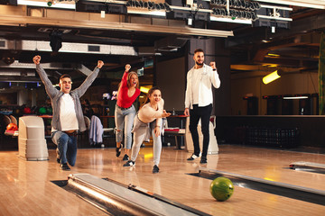 Group of young people having fun in a bowling alley