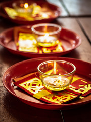 Candles in glass cups and joss papers
