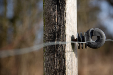 Electric fence around pastures with farm animals