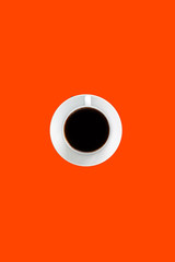 Black coffee espresso in white cup and saucer, bright red color background with empty space for text, unhealthy food concept  