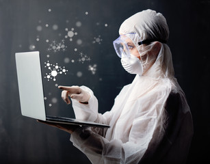 medic woman wearing protective clothing against the virus with laptop computer