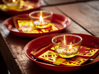Candles in glass cups and joss papers