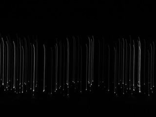 Abstract falling lines background. Many white lights going down on black background representing the concept of fall