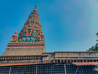 Stock photo of beautiful dravidian style temple tower, colorful sculpture of Hindu god and goddess...