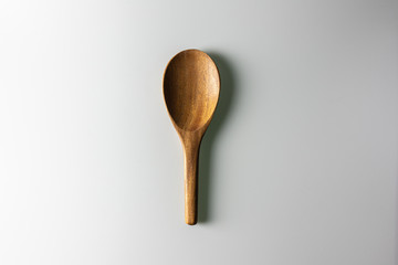 Wooden spoon on white background.