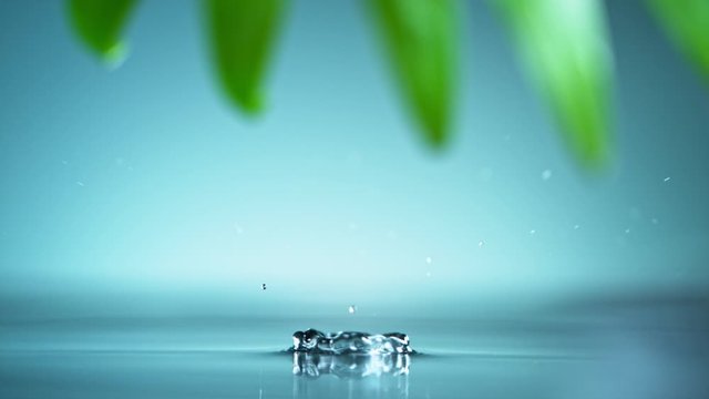 Macro shot of water drop over the water , relaxation with water ripple drops concept , filmed on cinema slow motion camera at 1000 fps
