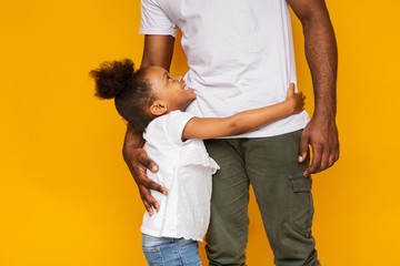 Cute african girl hugging and looking at her daddy