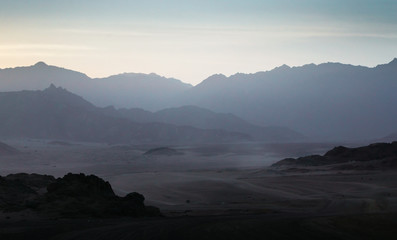 desert with rocky mountains and sky with clouds in the evening in Egypt