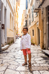 Obraz na płótnie Canvas Beautiful little kid on the streets of Corfu, Greece