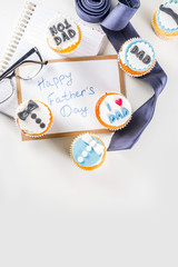 Happy Father’s Day greeting card.  Greetings and presents for Dad's day - gift box, coffee tea cup, tie, homemade special cupcakes.