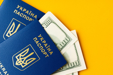 Ukrainian passport with heap of american dollars inside