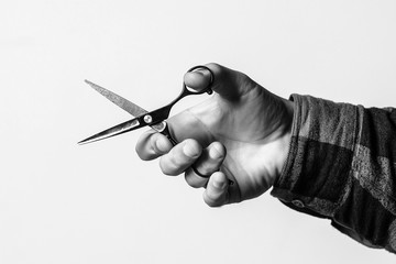 Barber scissors over background with copy space. Barber shop. Hairdresser hand holds scissors, cropped image.