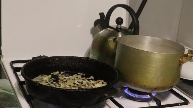 spaghetti cooking on gast stove with flame