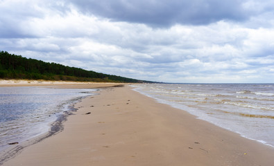 Clouds on a cloudy sky over the sandy beach of the Baltic Sea in Jurmala