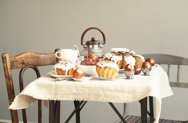 Easter baking with Easter eggs dyed with onion husks with imprints of fresh leaves, on a fabric canvas background. We meet Easter Sunday, tea drinking.