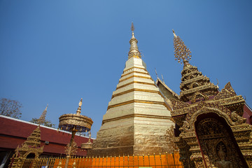 Fototapeta premium The golden pagoda at Wat Phra That Cho Hae in Phrae province, Thailand.