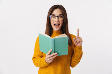 Image of beautiful brunette adult woman smiling and holding book