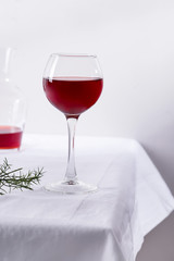 red wine in a wineglass with shadows isolated on white textile background