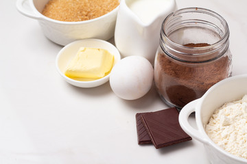 dessert baking ingredients: flour, cocoa, butter, milk