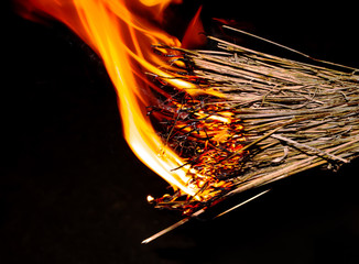 Burning bundle of hay in the dark