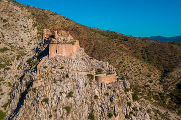 Fototapeta premium Aerial view of medieval Gothic Borriol hilltop castle ruin near Castellon Spain with blue sky