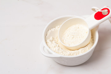 cup with flour on a white background close-up