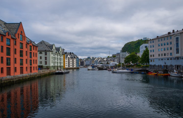 Fototapeta na wymiar Picturesque summer view of Alesund port town on the west coast of Norway, at the entrance to the Geirangerfjord. Colorful morning cityscape. Traveling concept background.