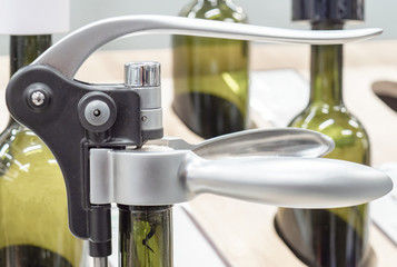 tool for pulling corks from wine bottles, consisting of a spiral that is inserted into the cork and a handle that extracts it