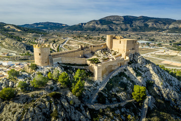 Fototapeta na wymiar Aerial view of Castalla castle in Valencia province Spain with donjon towering over the town and a courtyard reinforced with a circular tower on a sunny day with blue sky ground plan