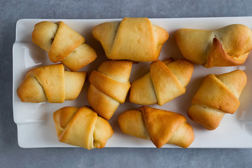 Homemade baking. Curls with jam on a white plate.