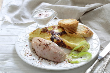 Baked chicken breast with spices and scrambled eggs with croutons